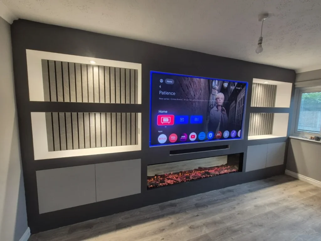 Wide bespoke media wall with open units, LED lighting and electric fire
