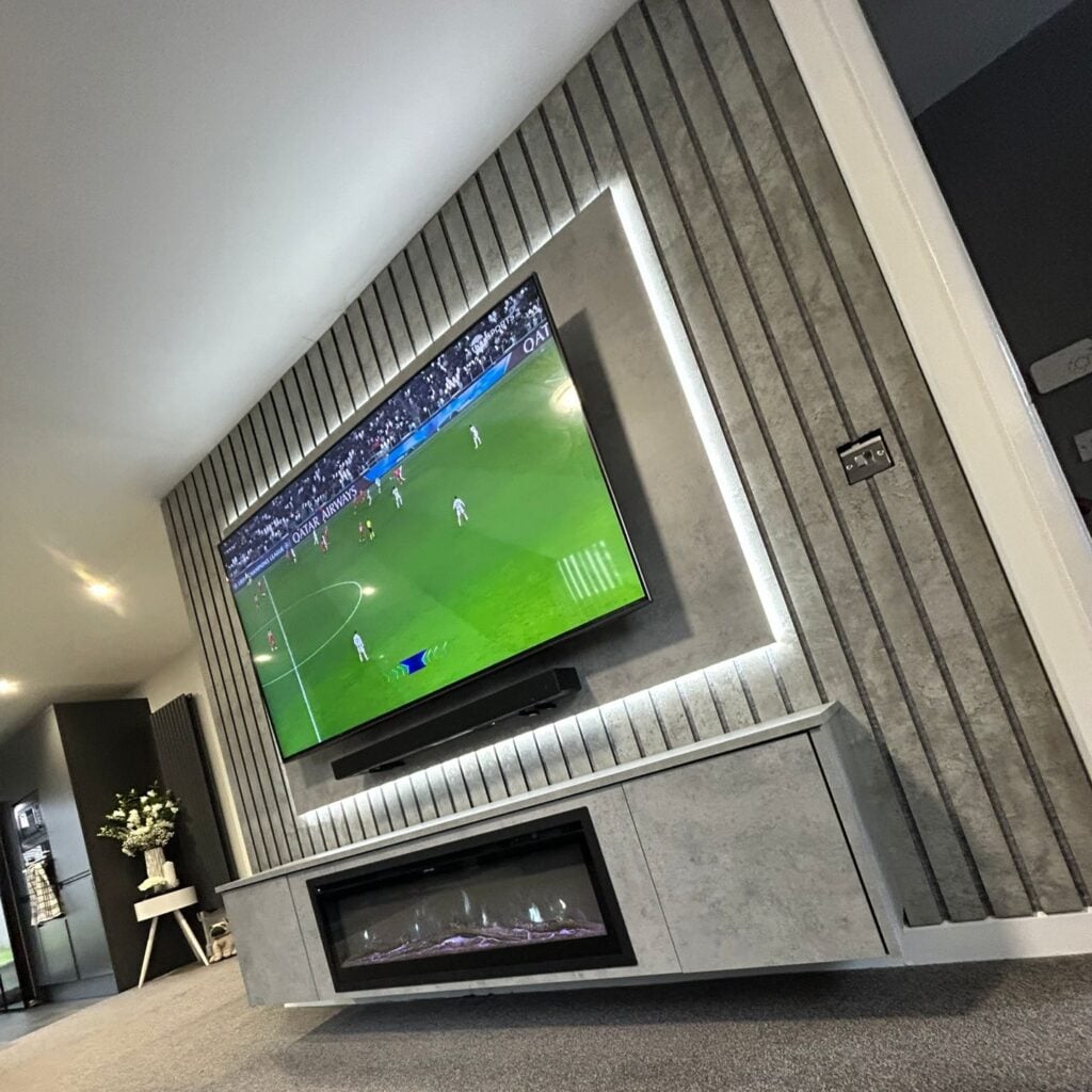 Media wall with slatted feature panel and built-in electric fire