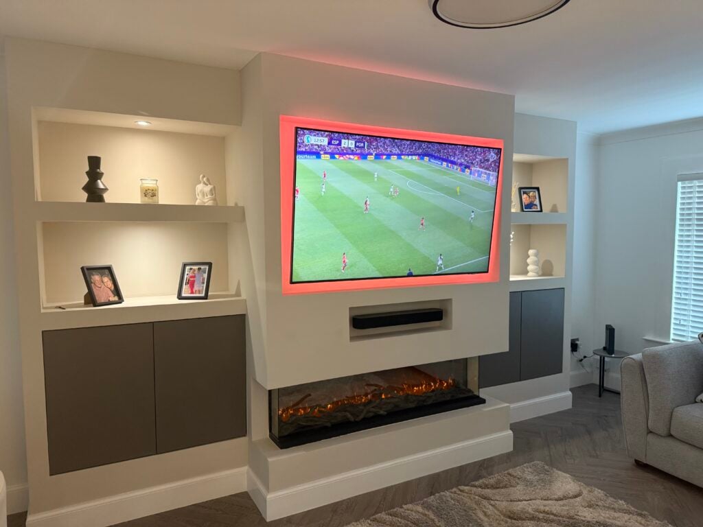 Bespoke media wall with open shelving, LED lighting and electric fire